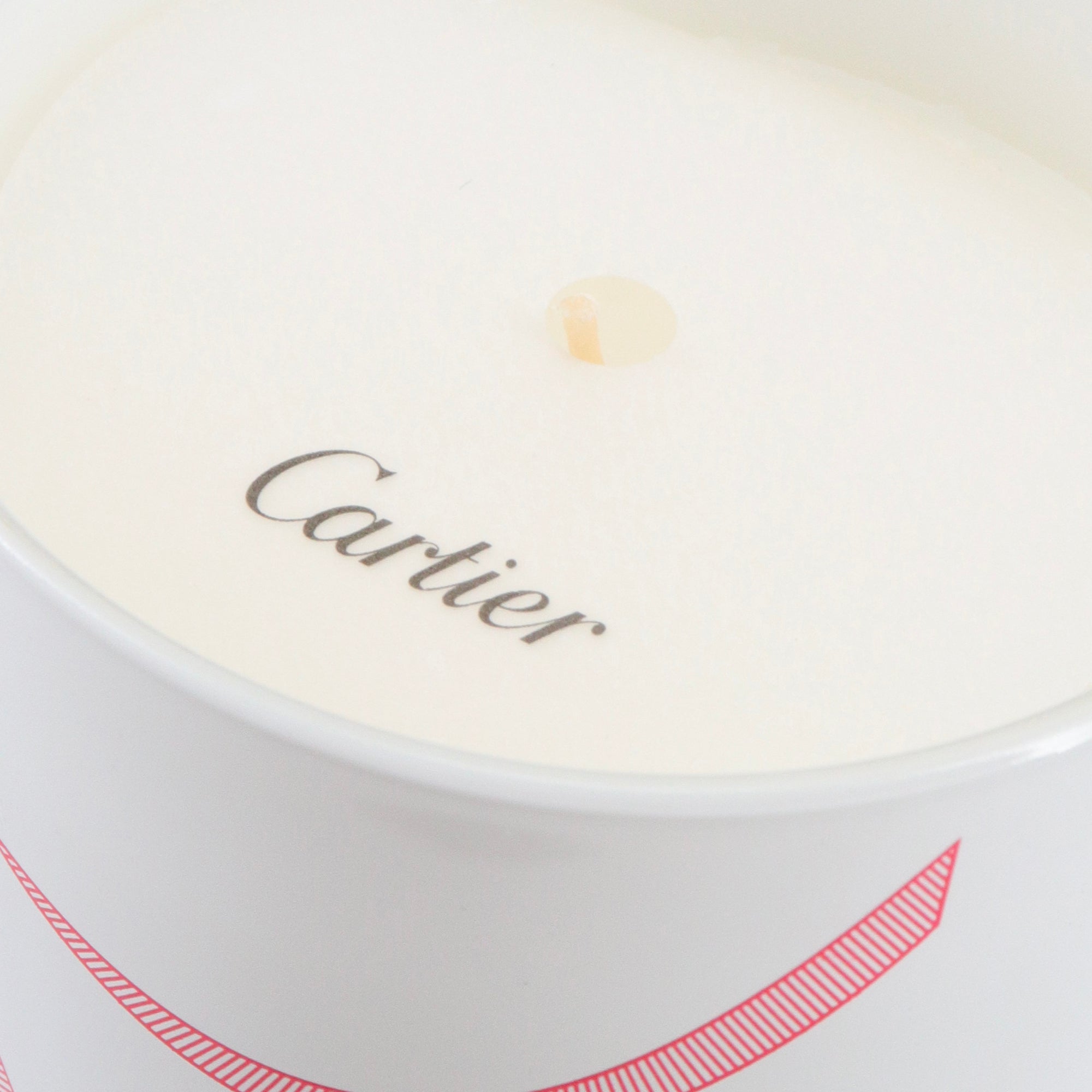 CARTIER - Bougie parfumée Cartier en verre blanc et rouge
