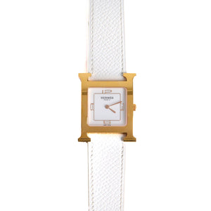 HERMÈS - Montre Heure H Hermès moyen modèle en or et cuir blanc