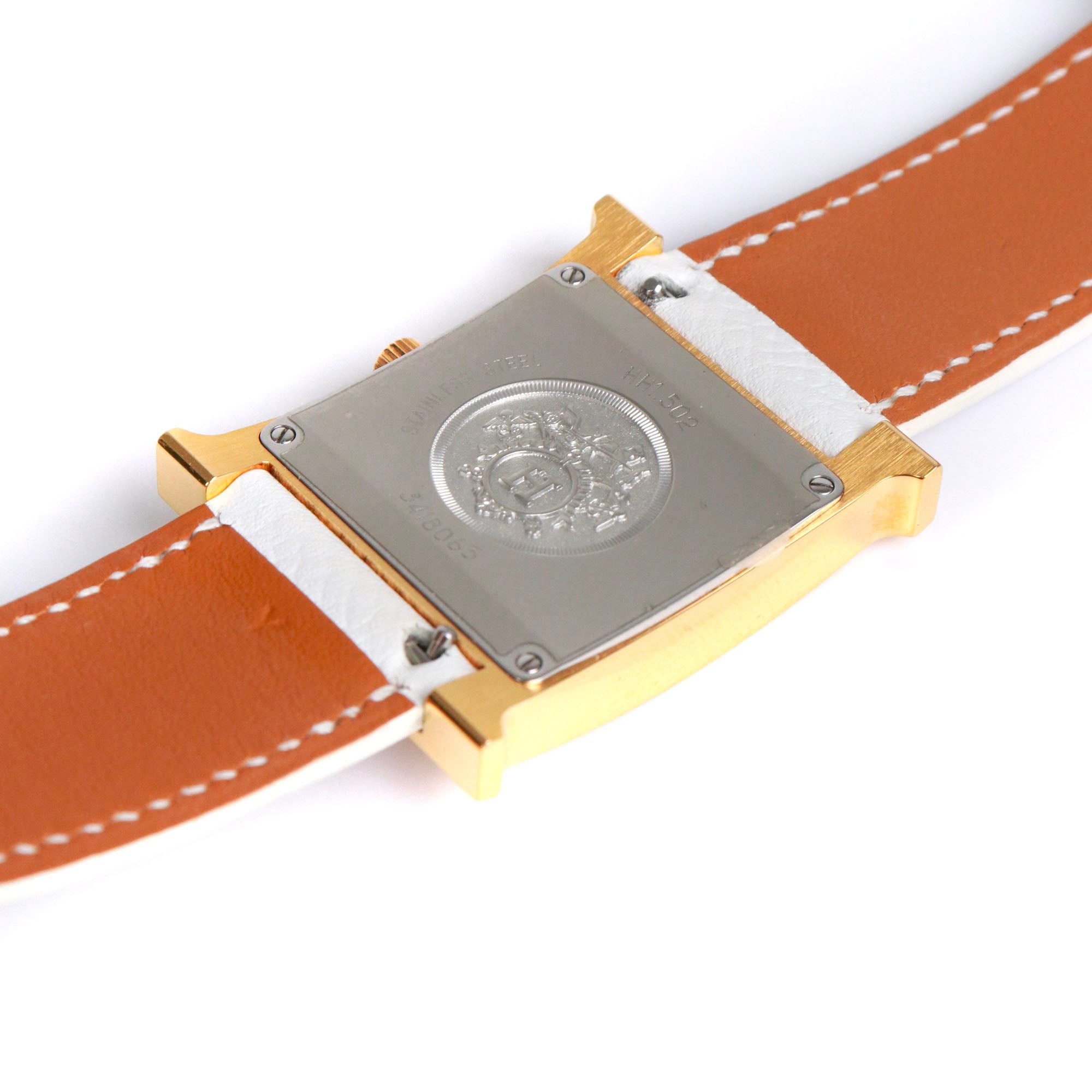 HERMÈS - Montre Heure H Hermès moyen modèle en or et cuir blanc