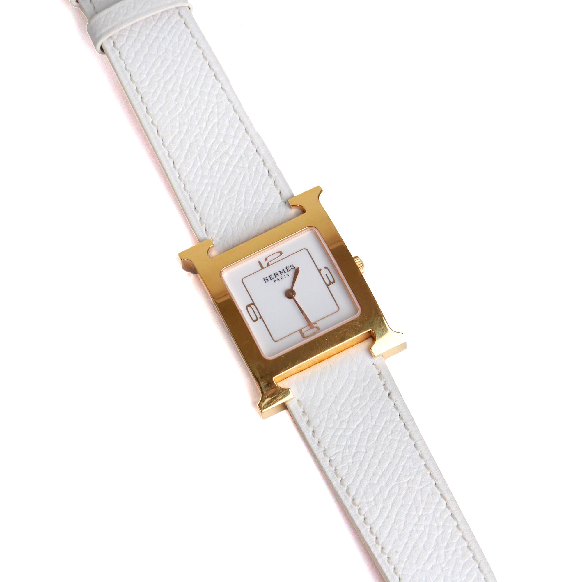 HERMÈS - Montre Heure H Hermès moyen modèle en or et cuir blanc