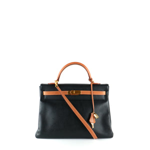 HERMÈS - Sac à main Kelly 35 en cuir togo bicolore noir et gold
