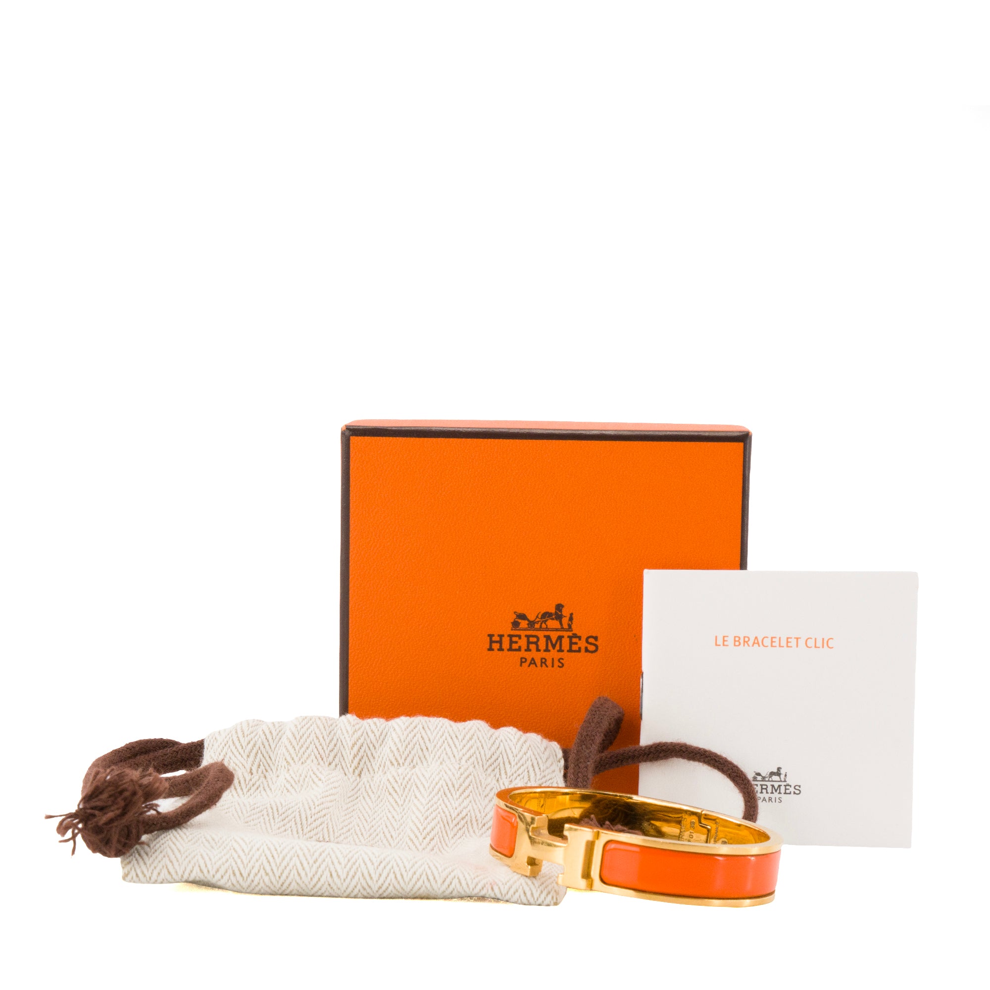 HERMÈS - Bracelet Clic H Hermès en métal doré et émail orange (PM)