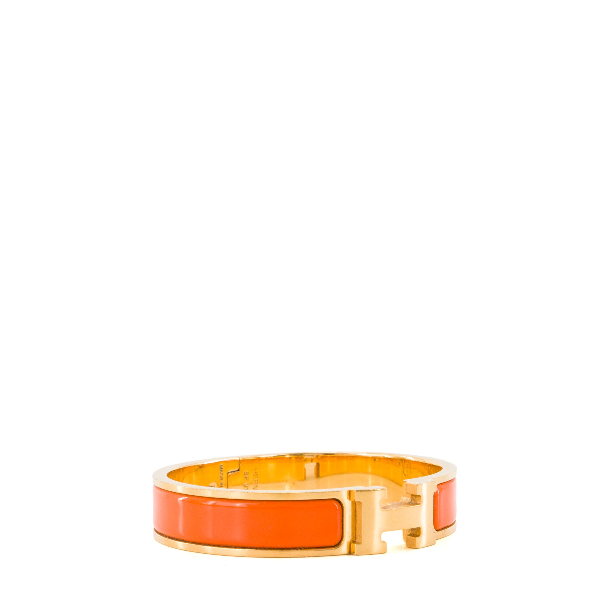 HERMÈS - Bracelet Clic H Hermès en métal doré et émail orange (PM)