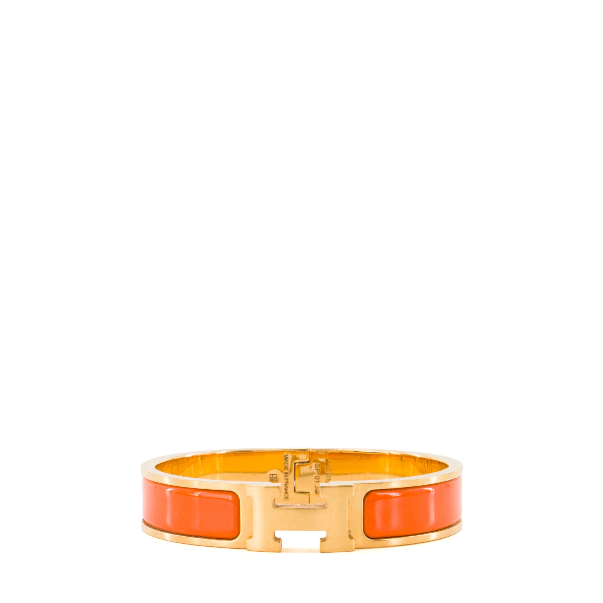 HERMÈS - Bracelet Clic H Hermès en métal doré et émail orange (PM)