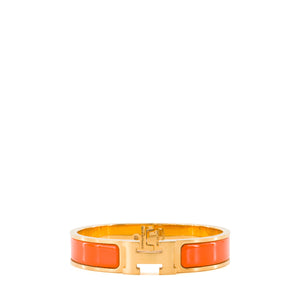 HERMÈS - Bracelet Clic H Hermès en métal doré et émail orange (PM)