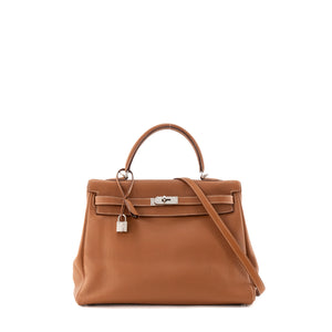 HERMÈS - Sac à main Kelly 35 Hermès en cuir clémence marron gold