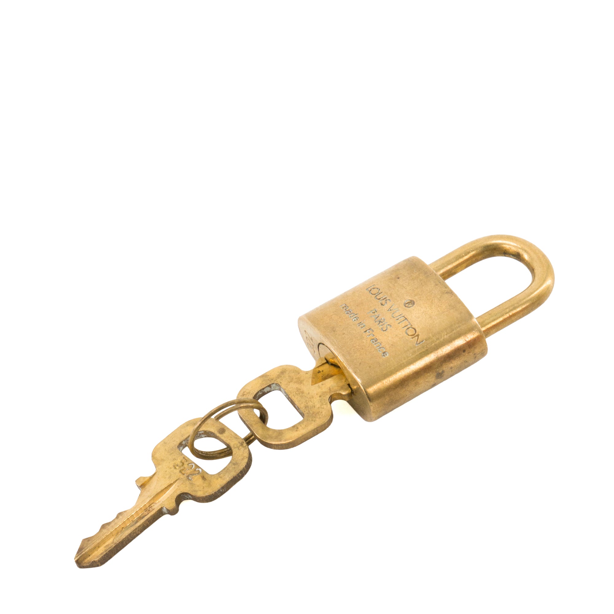 LOUIS VUITTON - Louis Vuitton padlock with key in gold-tone metal